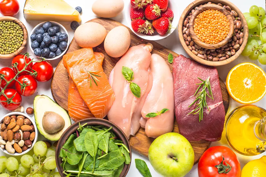 A photo of healthy foods spread out on a table that fit Dr. Nowzaradan's Diet Plan.