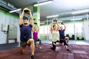 Group of People Doing Lunges In Gym