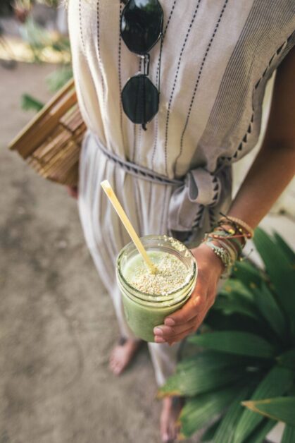 Girl Holding Green Juice with Straw in Mason Jar