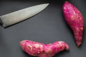 Purple Sweet Potatoes with large knife on table