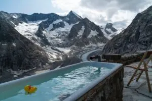 Yellow Toy Duck Floating in Pool in Snowy Mountains
