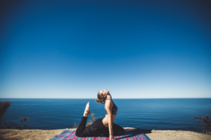 Woman Doing Yoga on Beach