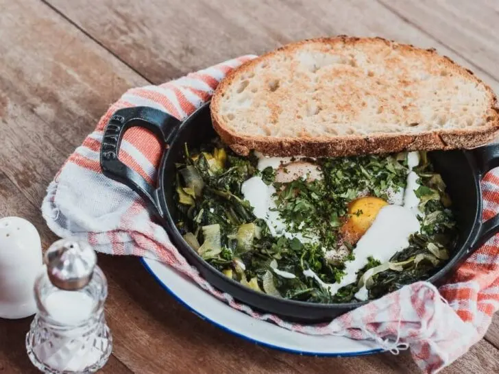 A sklillet with eggs and a Spinach bake, as featured on a blog about healthy eating hacks