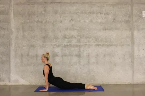 Woman Doing Yoga In Front of Blank Wall
