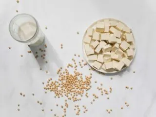 Cut tofu on a white table, as featured on a blog about healthy eating hacks