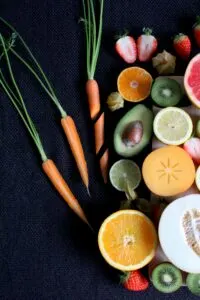 Sliced Fruits and Vegetables on Black Table