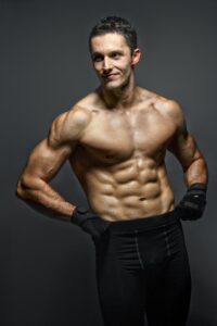 Man Wearing Black Pants with No Shirt Showing Abs