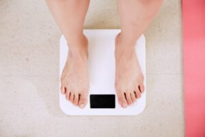 Person Standing Barefoot on Scale