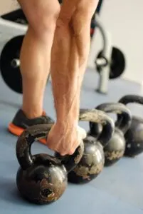 Guy Grabbing Kettlebell From Floor