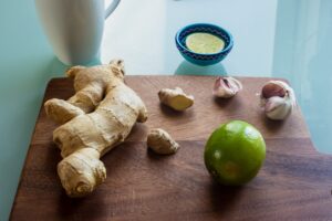 Cutting Board with Fresh Ginger, Lime and Garlic