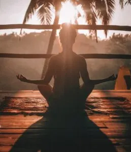 Woman Doing Yoga Meditation on Deck