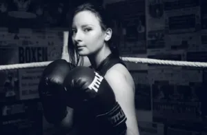 Woman in Boxing Ring With Hands Up