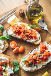 Plate with Tomata Salad Topping on Bread with Olive Oil Bottle