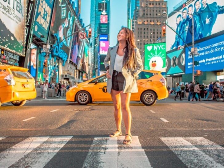 Woman Standing in Crosswalk in New York City with Traffic Behind