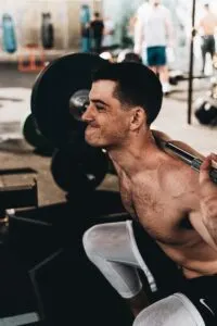 Guy Doing Back Squat With Stained Face