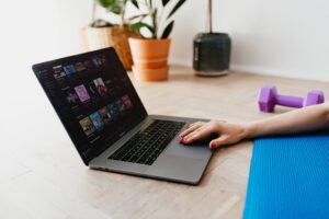 Woman Working on Laptop With Yoga Mat