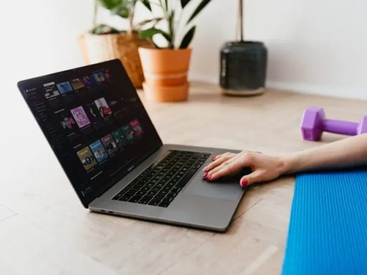 Woman Working on Laptop With Yoga Mat