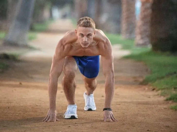 Shirtless Guy Preparing to Run From Crouched Position