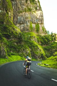 Guy Riding Road Bike on Mountain Road