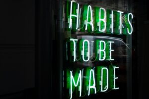 Green Neon Sign Saying Habits to be Made
