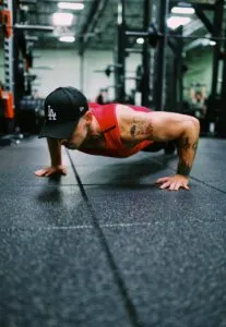 Guy at Bottom of Push Up Movement in Gym