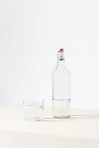 White Background with Glass Bottle and Glass of Water