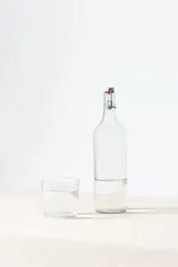 White Background with Glass Bottle and Glass of Water