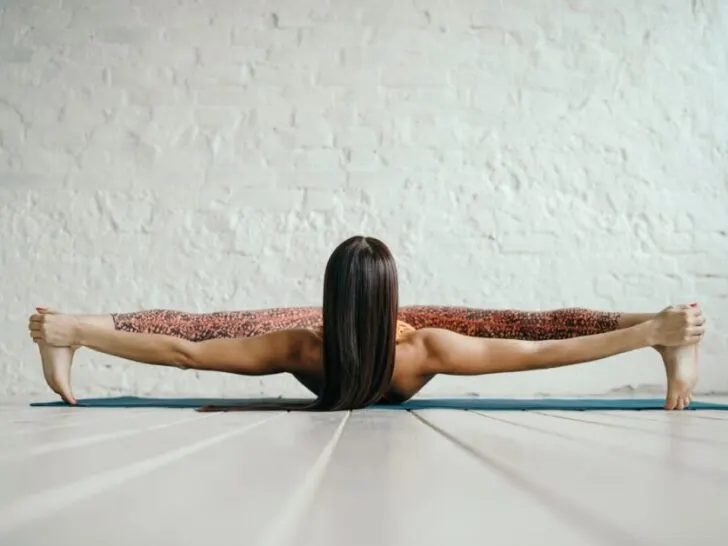 Woman Stretching on White Floor