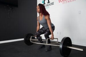 Woman in Gym Doing Deadlifts with Trap Bar