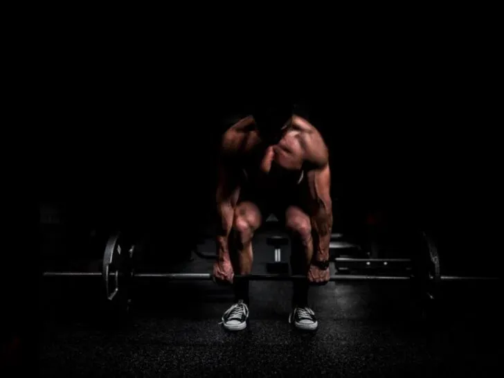 Shirtless Guy in Shadows Doing Barbell Deadlift