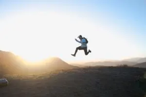 Guy Jumping on Mountain Trail