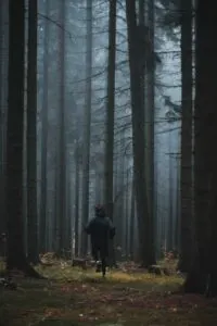 Runner Running Through Dark Woods