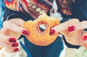 Woman Holding Partially Eaten Donut