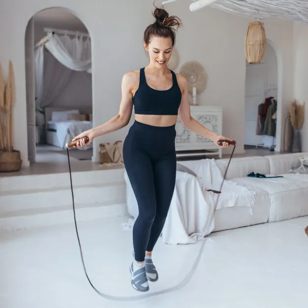 Girl Exercising With Jumping Rope At Home