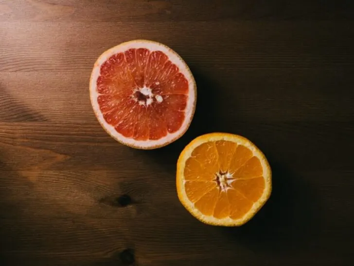 Sliced grapefruit and orange on brown table