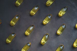 Collection of yellow pills on grey background