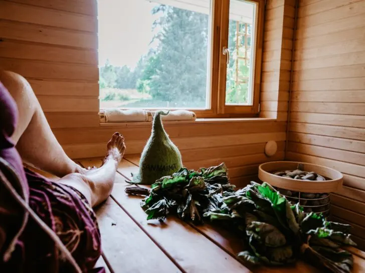 Woman's legs in a sauna with window open to nature.